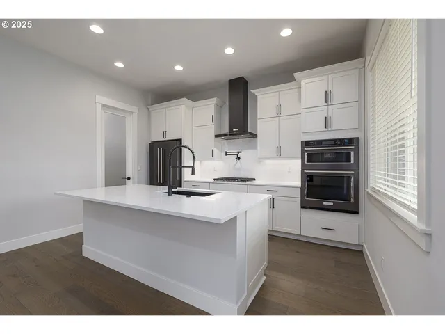 a kitchen with cabinets stainless steel appliances and counter space