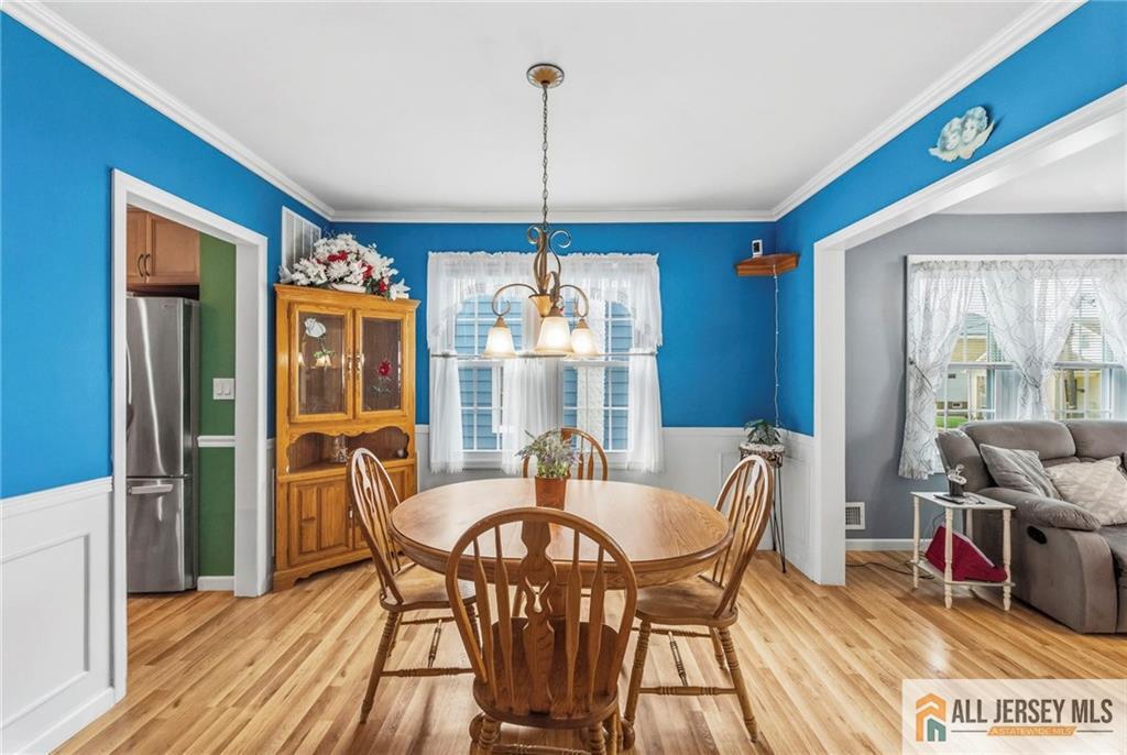 50 3rd Street Fords, NJ 08863 - Photo 9 of 36 a dining room with furniture a chandelier and wooden floor