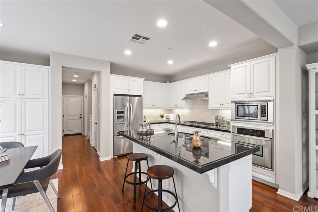 128 Long Grass Irvine, CA 92618 - Photo 11 of 42 a kitchen with stainless steel appliances granite countertop a stove refrigerator sink and cabinets