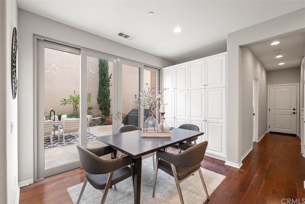 128 Long Grass Irvine, CA 92618 - Photo 16 of 42 a view of a dining room with furniture window and wooden floor