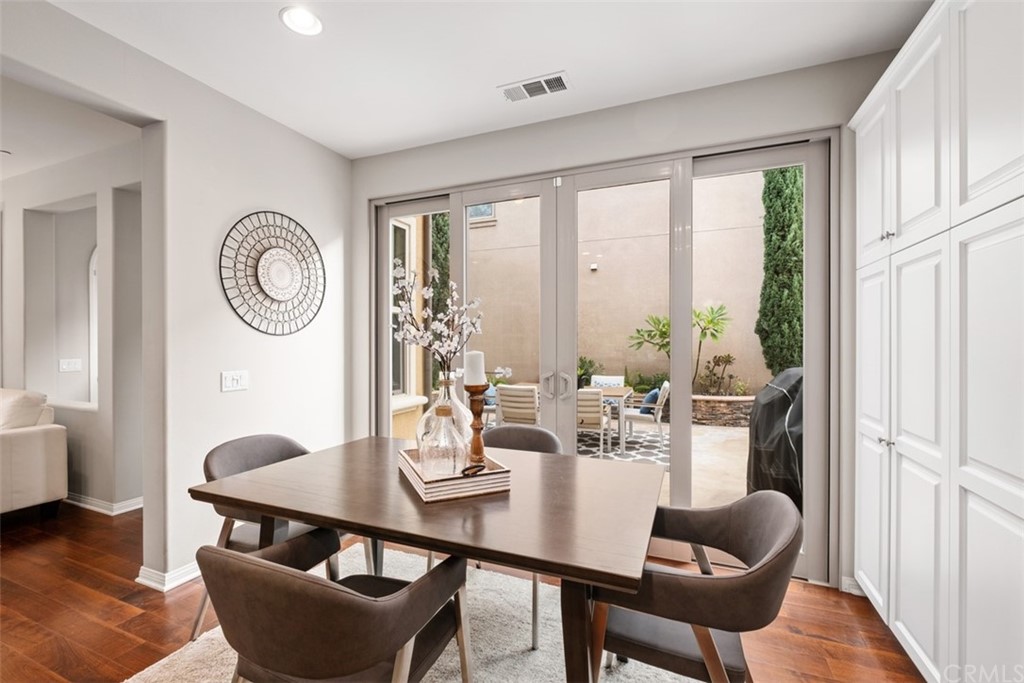 128 Long Grass Irvine, CA 92618 - Photo 17 of 42 a view of a dining room with furniture window and wooden floor