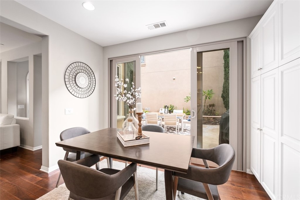 128 Long Grass Irvine, CA 92618 - Photo 18 of 42 a view of a dining room with furniture window and wooden floor