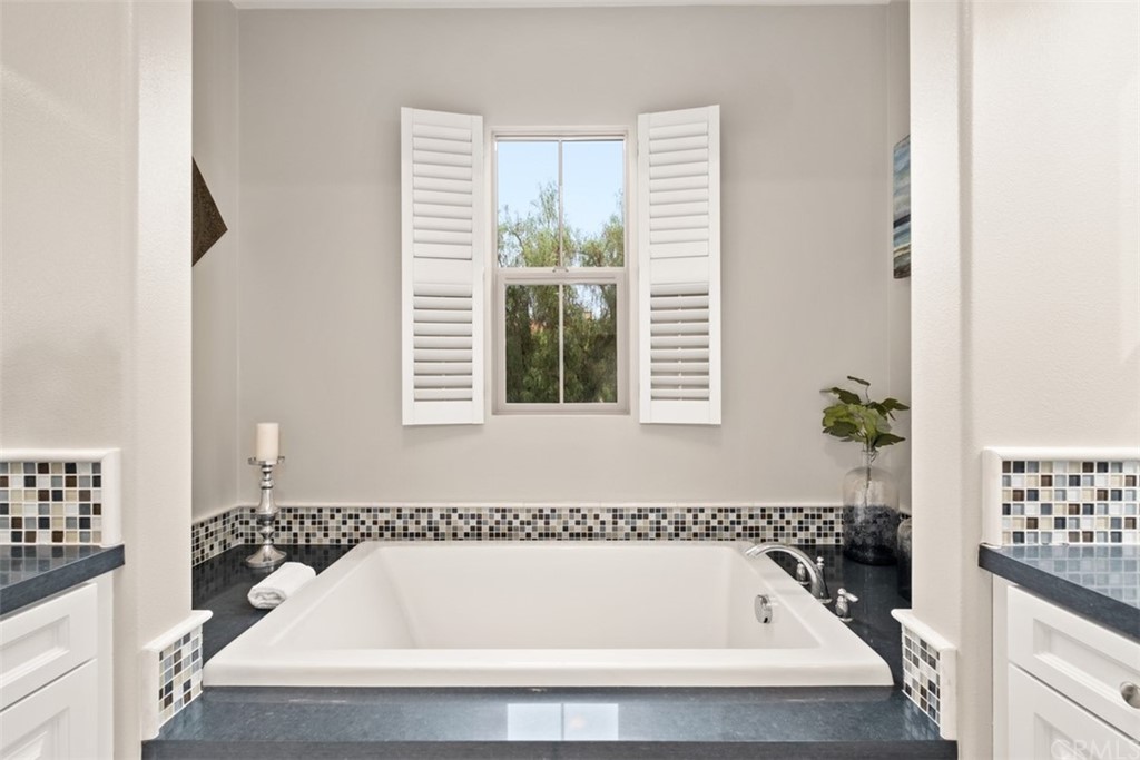 128 Long Grass Irvine, CA 92618 - Photo 24 of 42 a bathroom with bathtub and a window