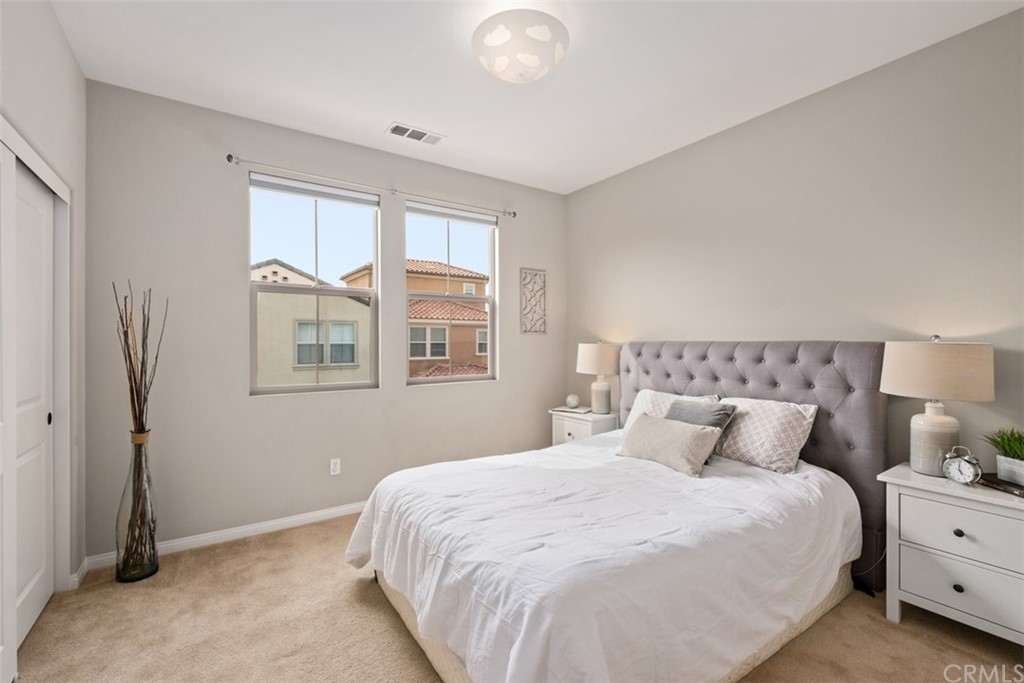 128 Long Grass Irvine, CA 92618 - Photo 27 of 42 a bedroom with a bed and a window