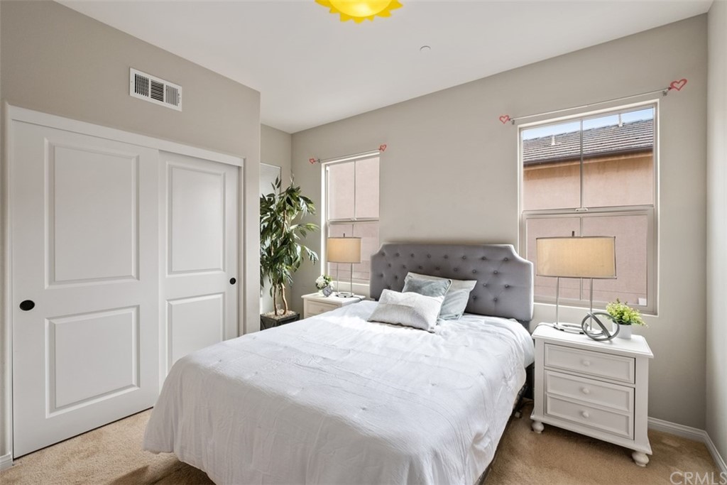 128 Long Grass Irvine, CA 92618 - Photo 30 of 42 a bedroom with a bed and a lamp