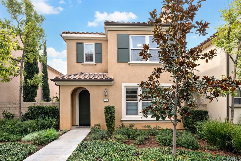 128 Long Grass Irvine, CA 92618 - Photo 4 of 42 a front view of a house with plants and trees
