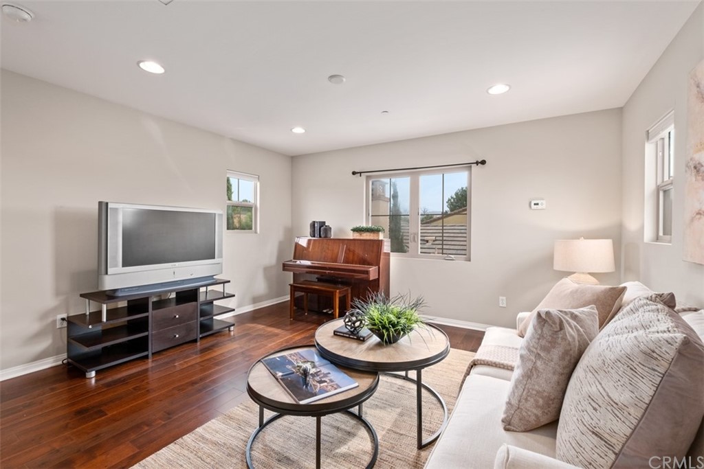 128 Long Grass Irvine, CA 92618 - Photo 32 of 42 a living room with furniture and a flat screen tv