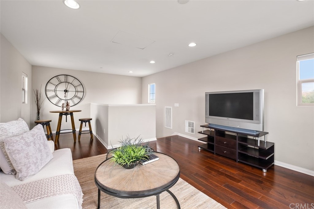 128 Long Grass Irvine, CA 92618 - Photo 33 of 42 a living room with furniture and a flat screen tv
