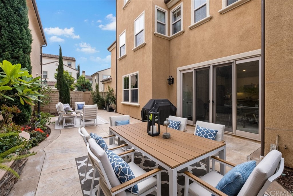 128 Long Grass Irvine, CA 92618 - Photo 38 of 42 a view of a patio with table and chairs and potted plants