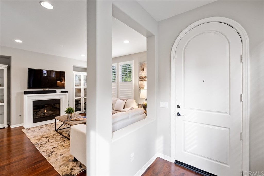 128 Long Grass Irvine, CA 92618 - Photo 7 of 42 a living room with furniture a flat screen tv and a fireplace