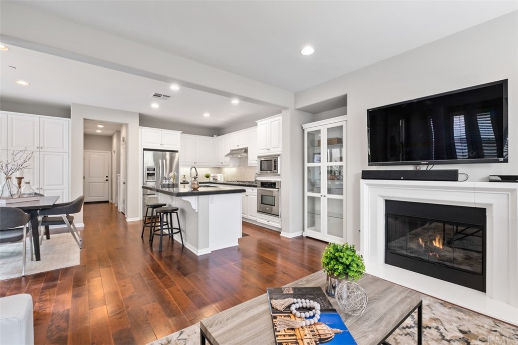 128 Long Grass Irvine, CA 92618 - Photo 10 of 42 a living room with furniture a flat screen tv and a fireplace