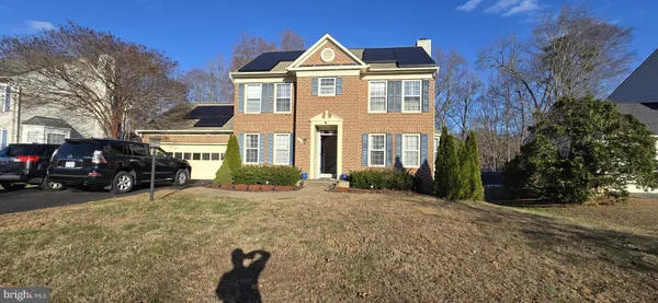 a view of a brick house next to a yard