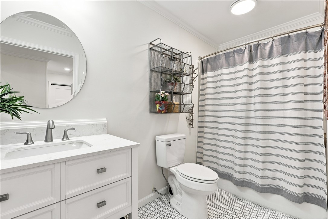 204 Sylvia Road Easley, SC 29642 - Photo 25 of 36 A refined bathroom featuring a clean vanity with sleek fixtures and mosaic tile flooring.