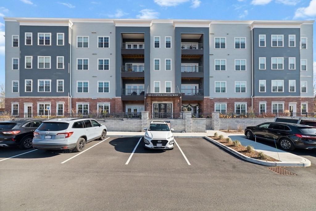 60 Coppersmith Way, Unit 404 Canton, MA 02021 - Photo 2 of 42 a view of a street that has couple of cars parked in front of it