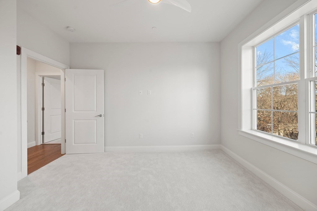 60 Coppersmith Way, Unit 404 Canton, MA 02021 - Photo 21 of 42 a view of an empty room with a window