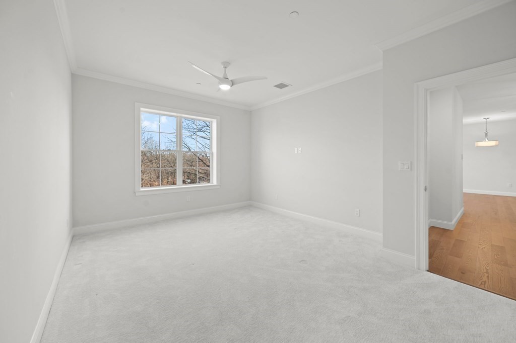 60 Coppersmith Way, Unit 404 Canton, MA 02021 - Photo 27 of 42 an empty room with windows and ceiling fan