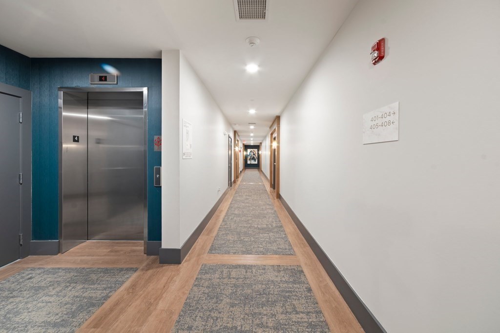 60 Coppersmith Way, Unit 404 Canton, MA 02021 - Photo 36 of 42 a hallway with wooden floor and entryway