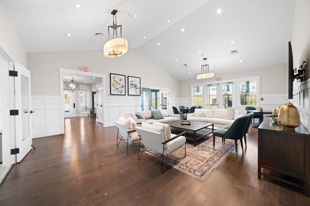 60 Coppersmith Way, Unit 404 Canton, MA 02021 - Photo 39 of 42 a living room with lots of furniture and a chandelier
