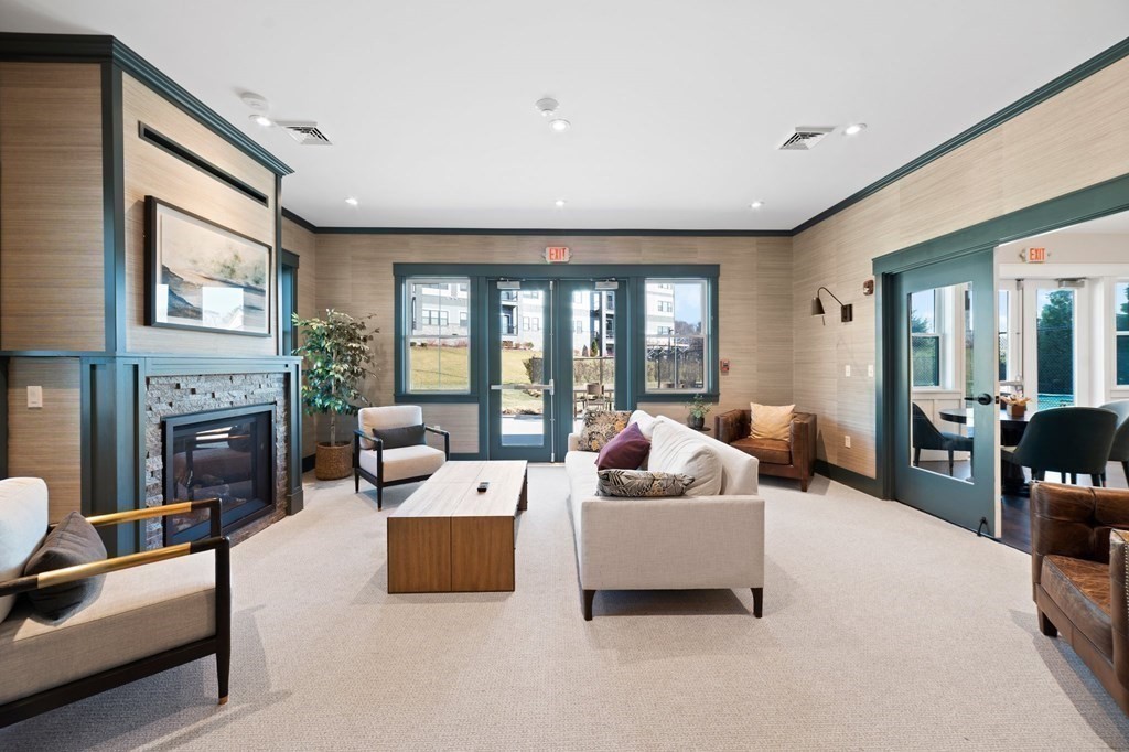 60 Coppersmith Way, Unit 404 Canton, MA 02021 - Photo 40 of 42 a living room with furniture and fireplace