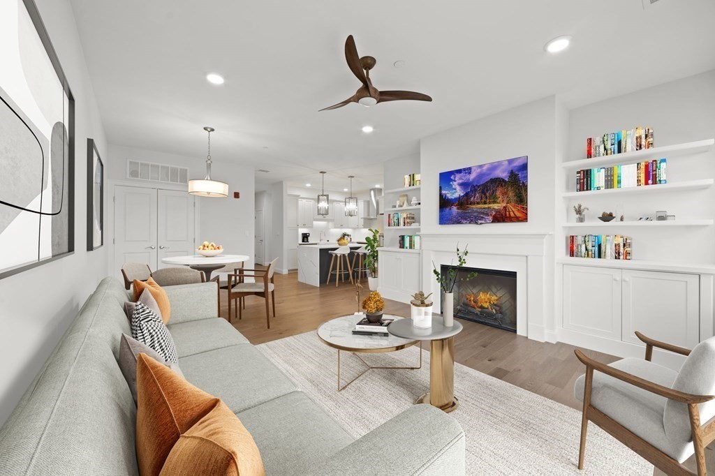 60 Coppersmith Way, Unit 404 Canton, MA 02021 - Photo 4 of 42 a living room with furniture a fireplace and a flat screen tv