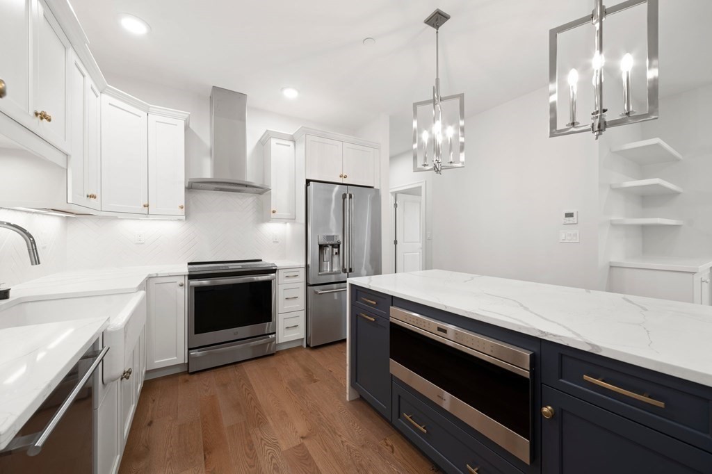60 Coppersmith Way, Unit 404 Canton, MA 02021 - Photo 9 of 42 a kitchen with stainless steel appliances granite countertop a sink stove and refrigerator