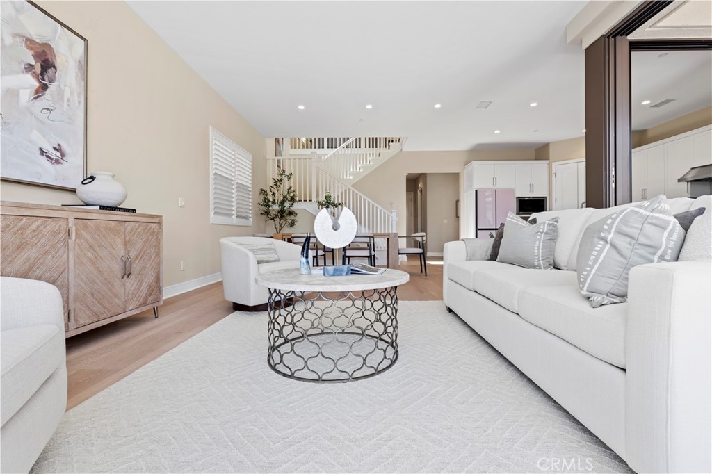 128 Tomahawk Irvine, CA 92618 - Photo 16 of 62 a living room with furniture a couch and a painting on the wall