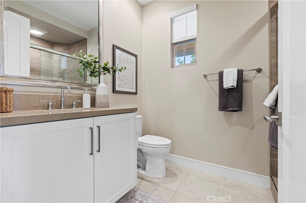128 Tomahawk Irvine, CA 92618 - Photo 19 of 62 a bathroom with a toilet sink and mirror
