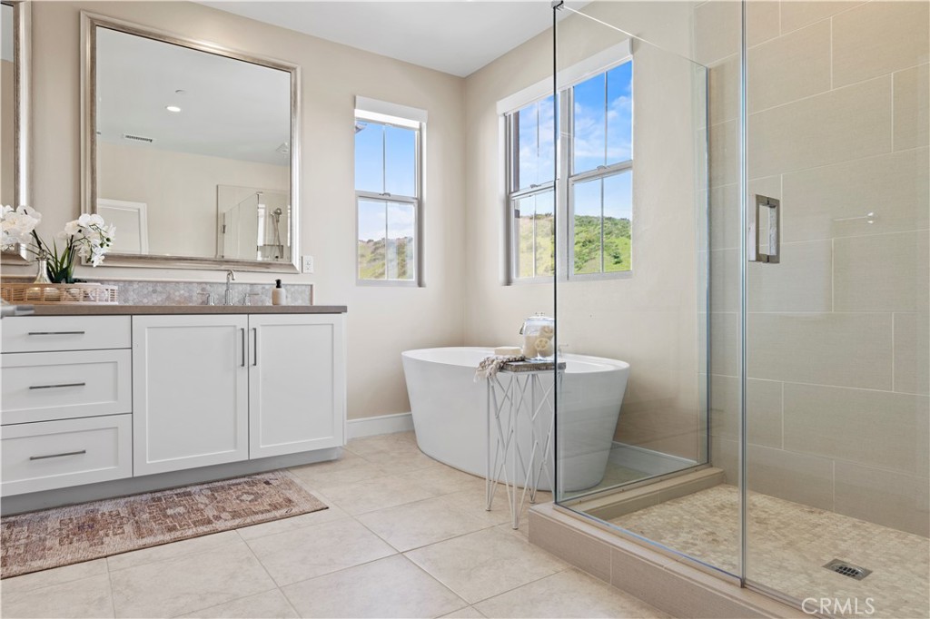 128 Tomahawk Irvine, CA 92618 - Photo 35 of 62 a bathroom with a sink a mirror and a bathtub