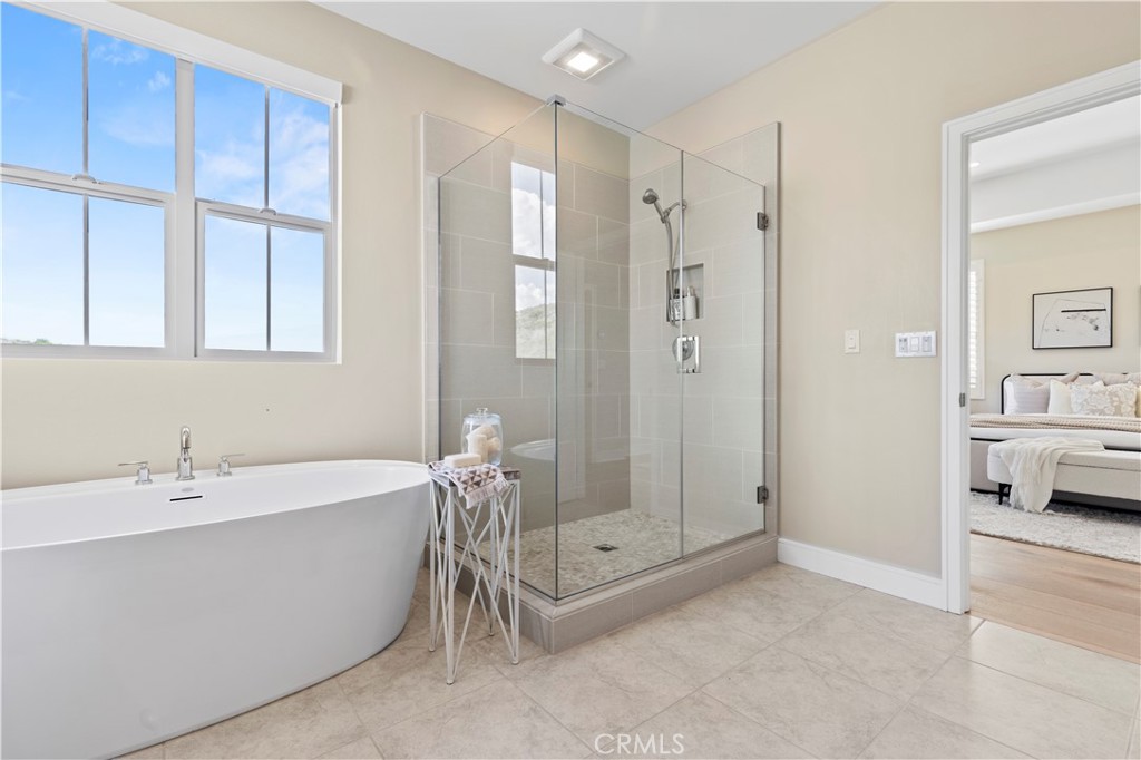 128 Tomahawk Irvine, CA 92618 - Photo 38 of 62 a spacious bathroom with a tub shower and mirror