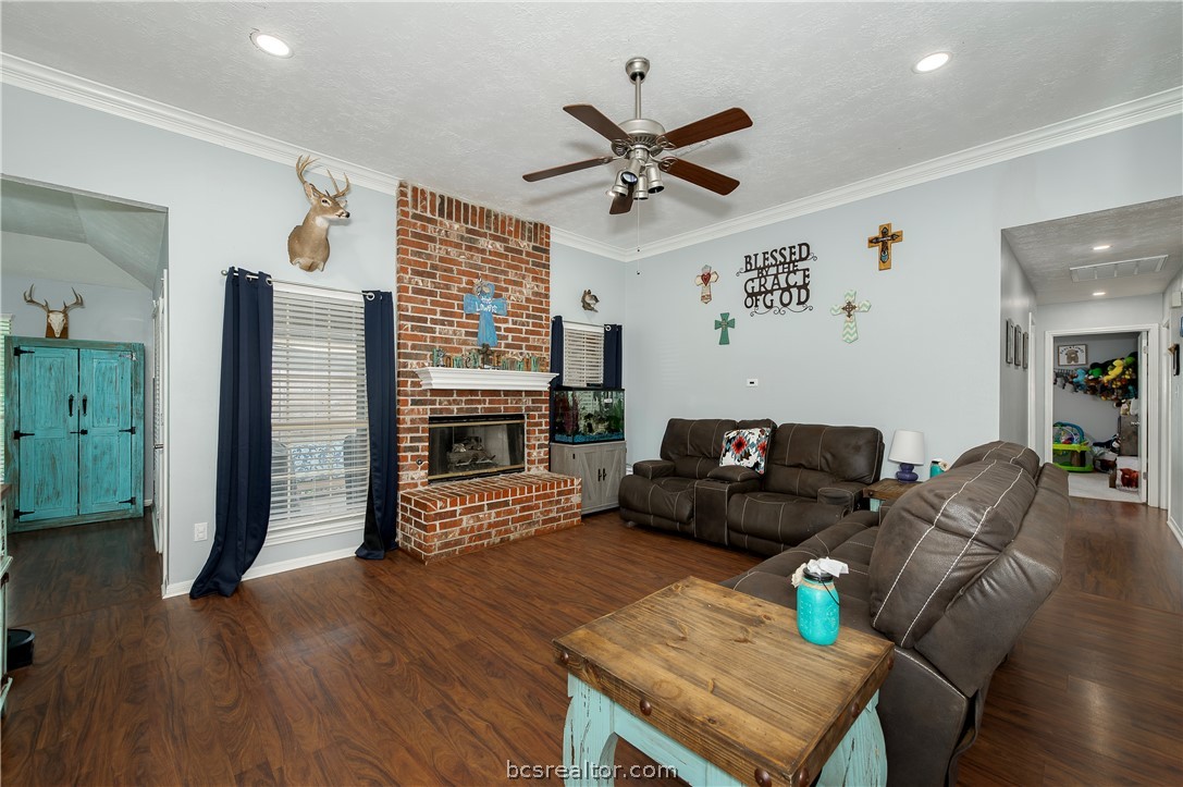 2009 Cobblestone Lane Bryan, TX 77807 - Photo 5 of 23 a living room with furniture a fireplace and a flat screen tv