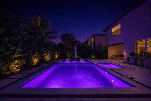 a view of house with swimming pool outdoor seating