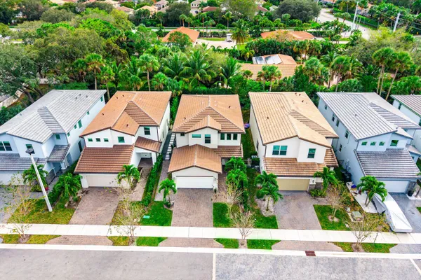 an aerial view of a house with outdoor space and a street view