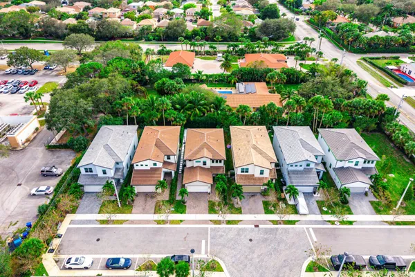 an aerial view of a house with a yard and potted plants