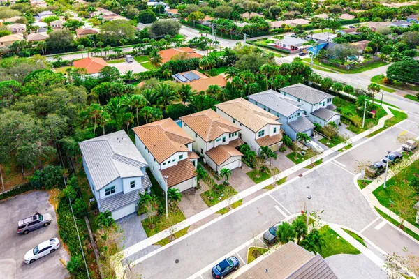 an aerial view of a house with a yard and potted plants