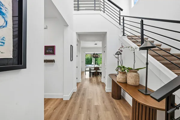 a view of entryway and hall with wooden floor