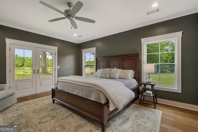 a spacious bedroom with a bed and a large window with outer view