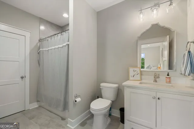 a bathroom with a toilet sink and shower