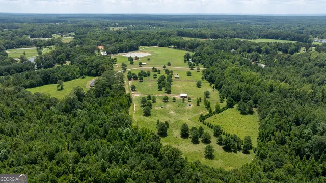 an aerial view of a houses with a yard