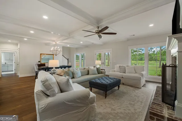 a living room with furniture ceiling fan and a rug