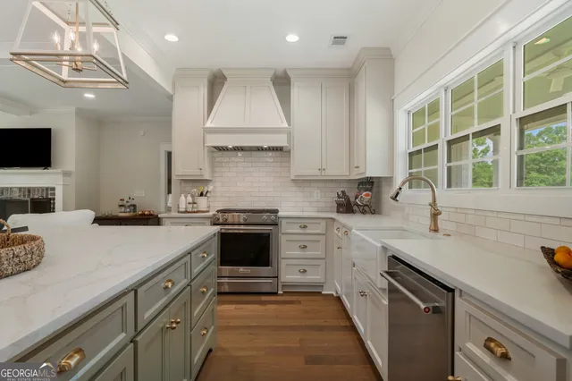 a kitchen with a sink stove top oven and cabinets