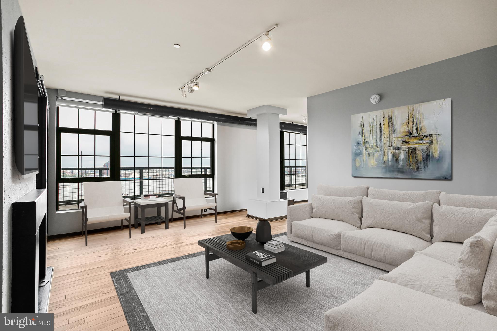1200 Steuart Street, Unit 1913 Baltimore, MD 21230 - Photo 1 of 39 a living room with furniture and a large window