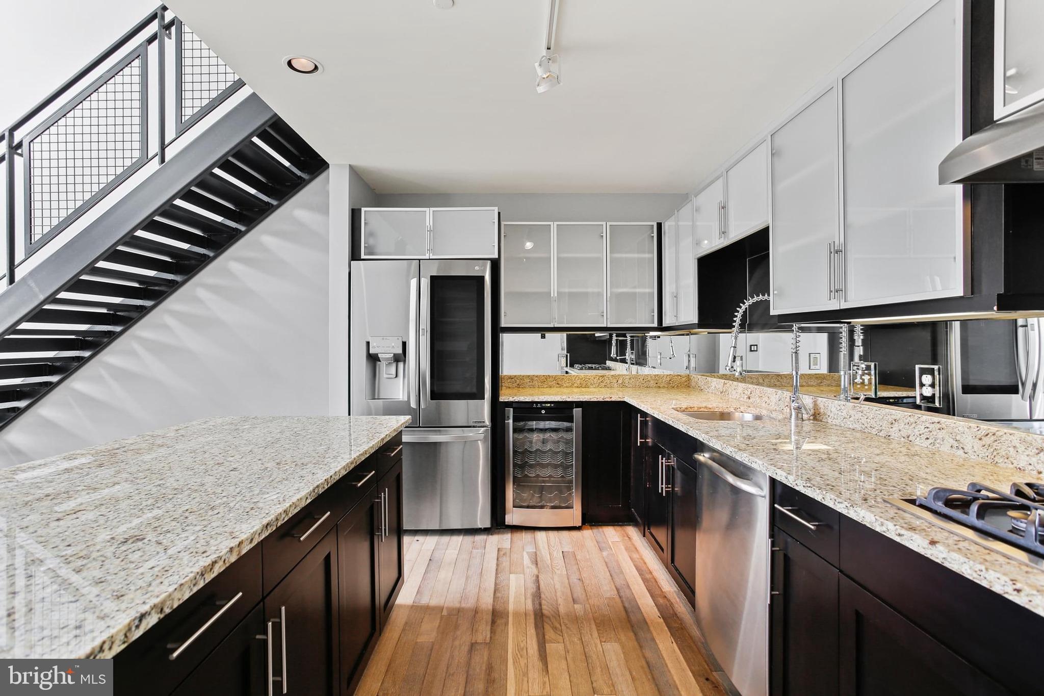 1200 Steuart Street, Unit 1913 Baltimore, MD 21230 - Photo 14 of 39 a kitchen with stainless steel appliances granite countertop a sink and stove
