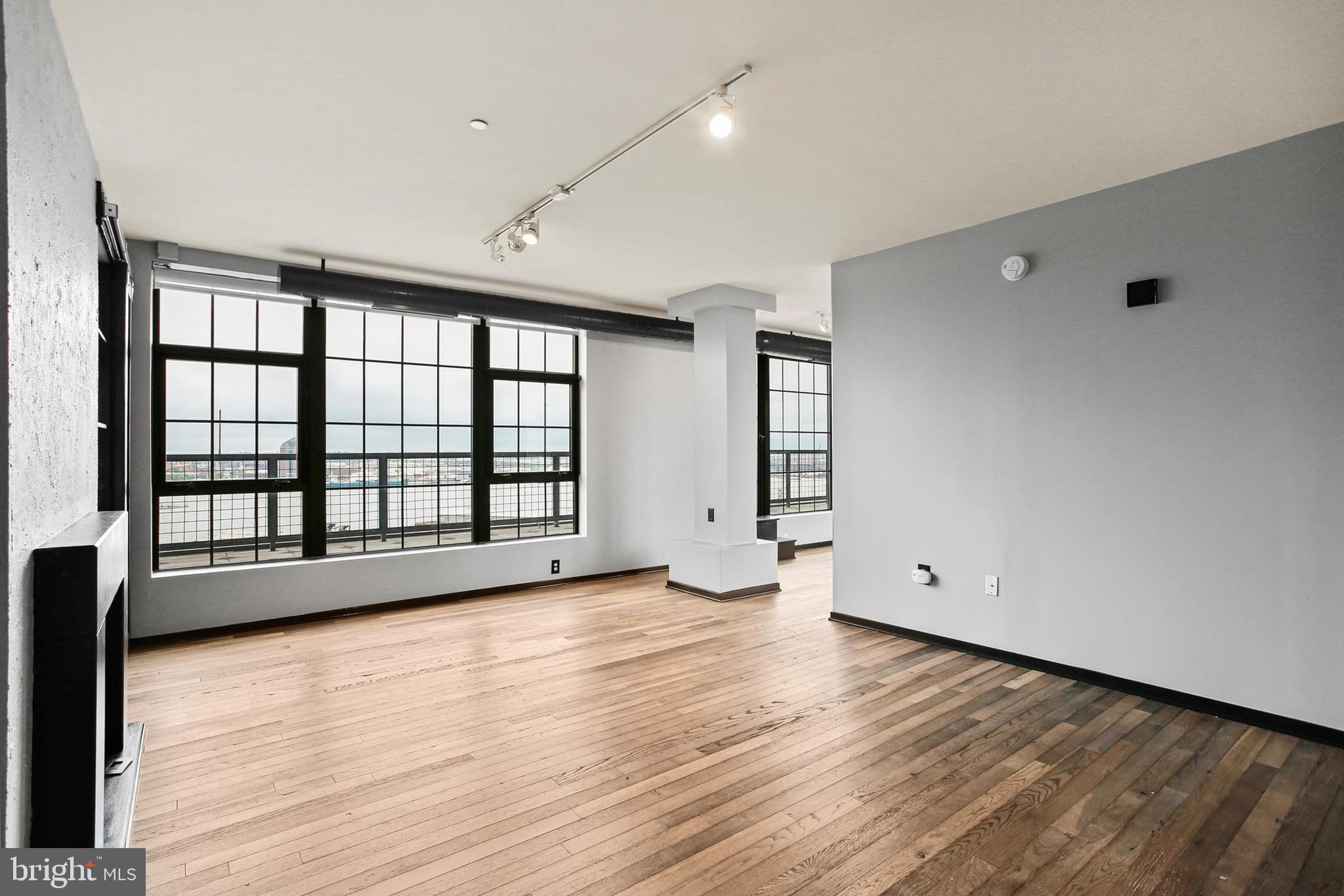 1200 Steuart Street, Unit 1913 Baltimore, MD 21230 - Photo 2 of 39 wooden floor in an empty room with a window