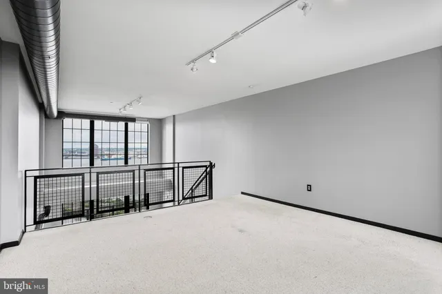 a spacious bedroom with a bed and a large window