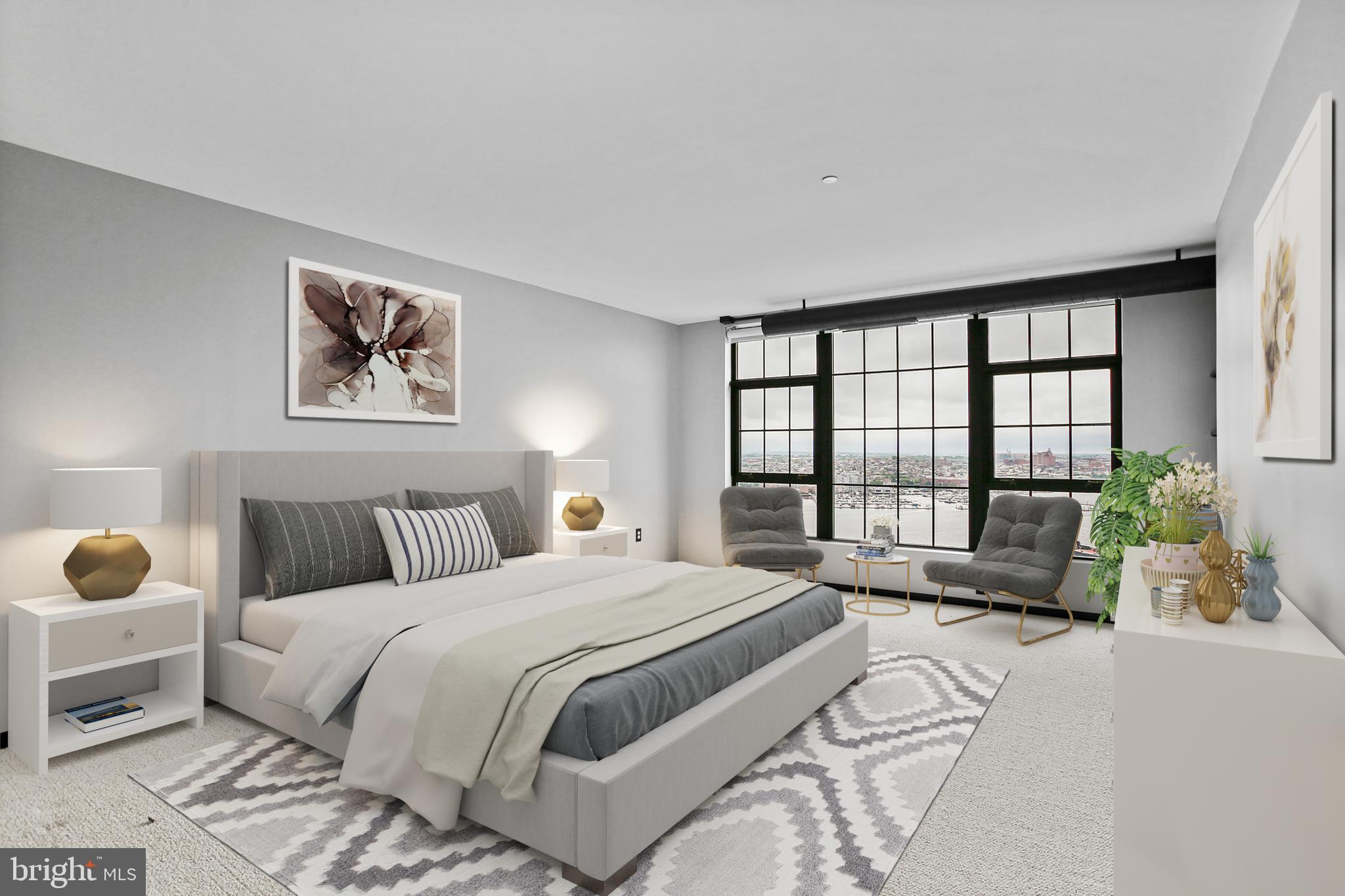 1200 Steuart Street, Unit 1913 Baltimore, MD 21230 - Photo 22 of 39 a spacious bedroom with a bed and a large window