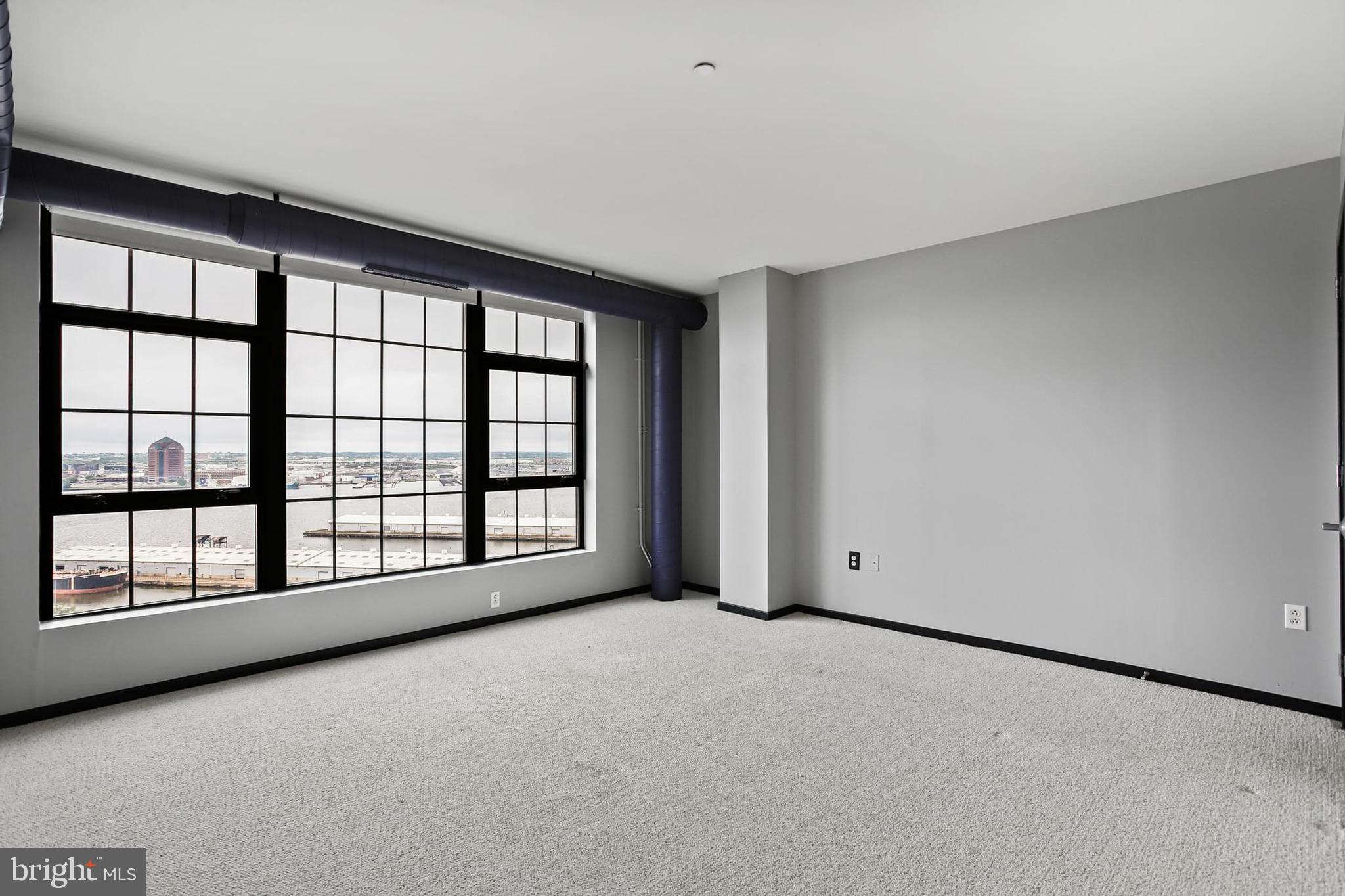 1200 Steuart Street, Unit 1913 Baltimore, MD 21230 - Photo 32 of 39 a view of an empty room with a window