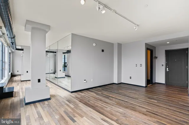 a view of an empty room and wooden floor