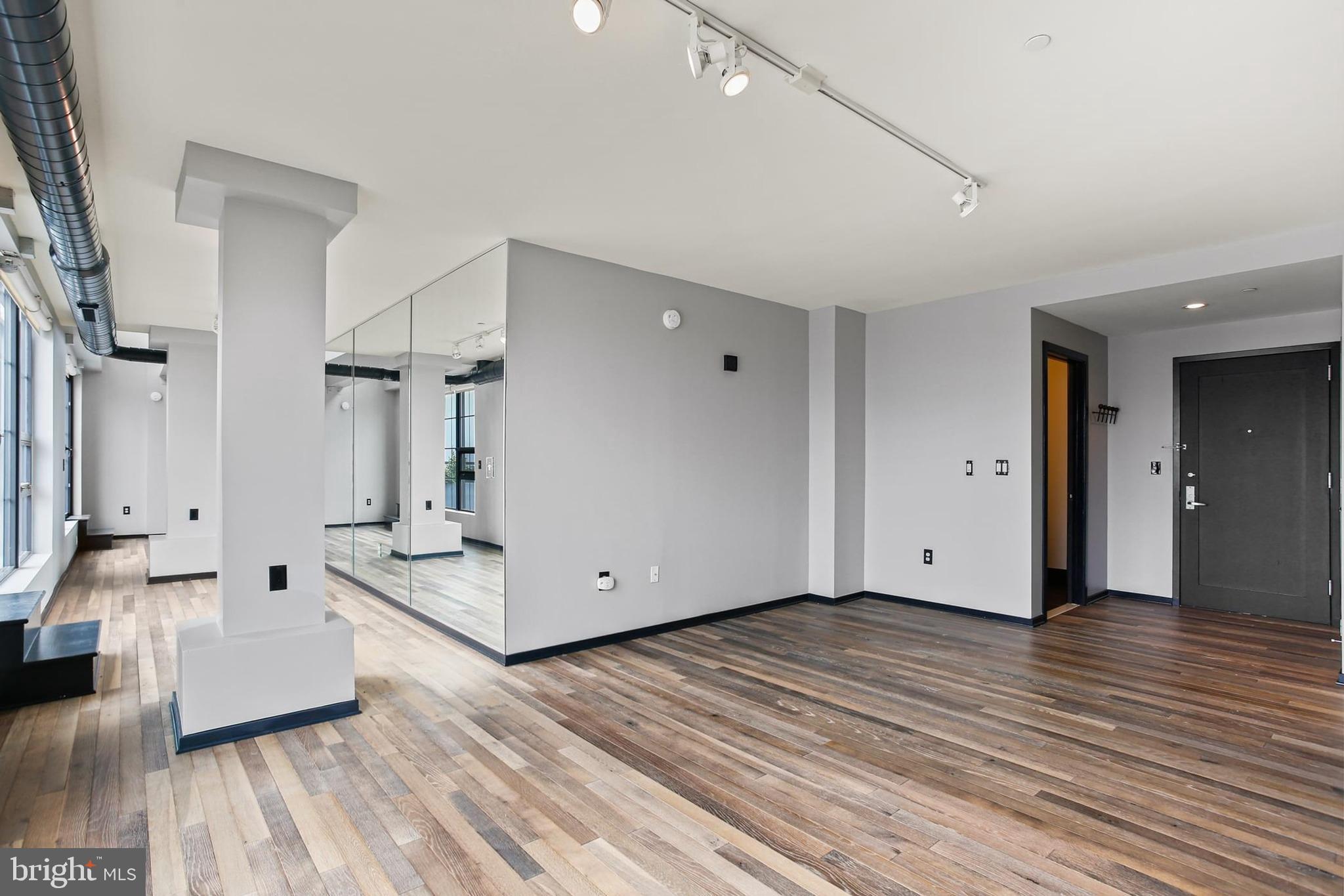 1200 Steuart Street, Unit 1913 Baltimore, MD 21230 - Photo 6 of 39 a view of an empty room and wooden floor
