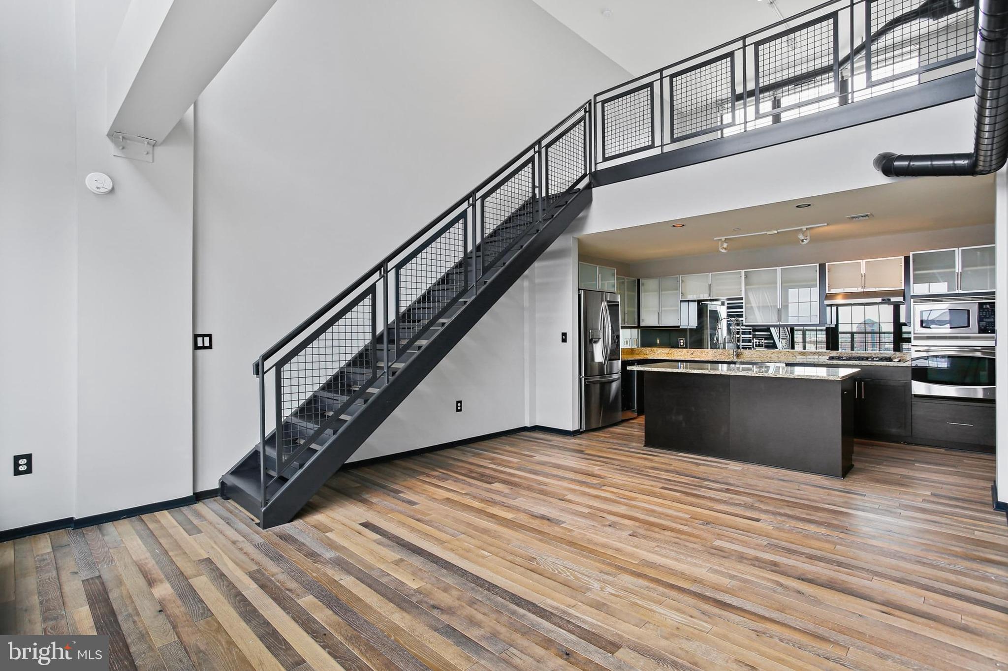 1200 Steuart Street, Unit 1913 Baltimore, MD 21230 - Photo 10 of 39 a view of kitchen with sink and wooden floor