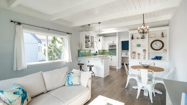a living room with kitchen island furniture and a large window